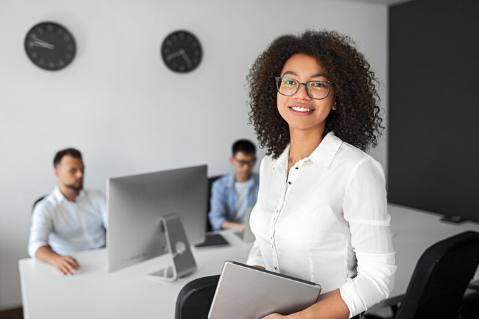 Positive Modern Female Manager In Formal White Shirt And Eyeglas