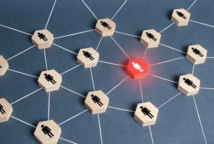 Red Human Figure In A Network. Leader And Leadership Skills. Tea
